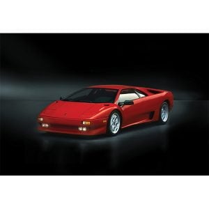 The Diablo was produced between 1990 and 2001. During this period, Lamborghini introduced several variations of the Diablo concept, the first being the Diablo VT (Visco Traction), which featured an all-wheel drive. The Diablo was destined to become the worthy heir of the renowned Miura and Countach. This newsupercar was wide, low and futuristic. And just like its predecessors, the Diablo soon became a favorite among car enthusiasts across the world. The Diablo models helped build the legend of Lamborghini and sold well. Almost 3,000 units across all series and variations found their buyers in those eleven years of evolution. The Lamborghini bosses had wished for a maximum speed of at least 320 kph, and the engineers made this wish come true: With a top speed of 325 kph and an acceleration from 0-100 in 4.5 seconds the Diablo claimed the pole position in the super sports cars segment. It delivered its power via a rear-wheel drive and came with a newly developed V12 engine. Four valves per cylinder, a computer controlled multi-point fuel injection and a displacement of 5.7 liters helped produce a maximum of 492 HP.