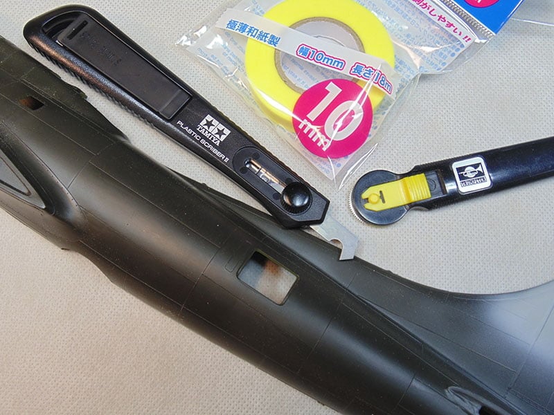 plastic part with tape and tools