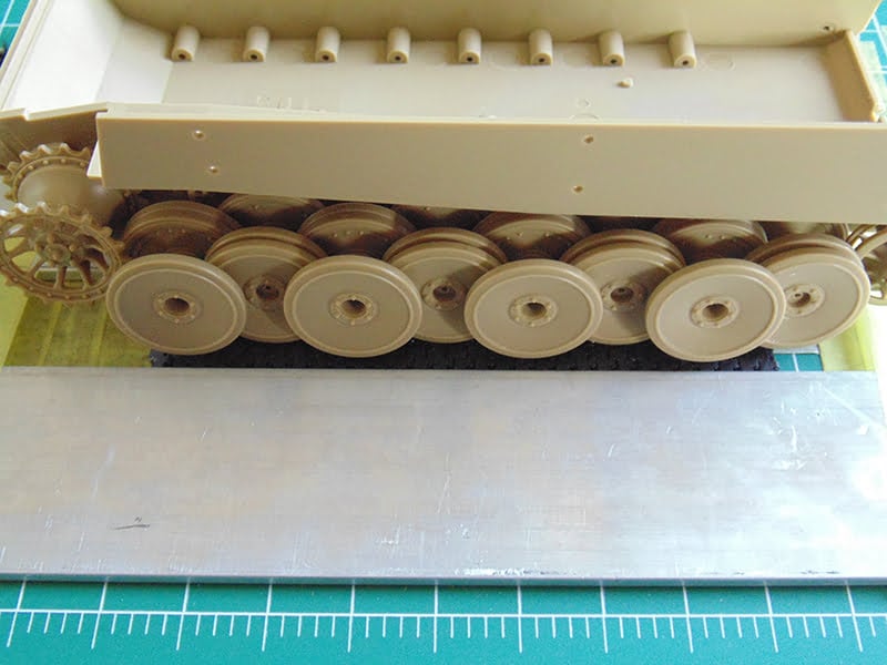 road wheel on top of the track length with metal bar