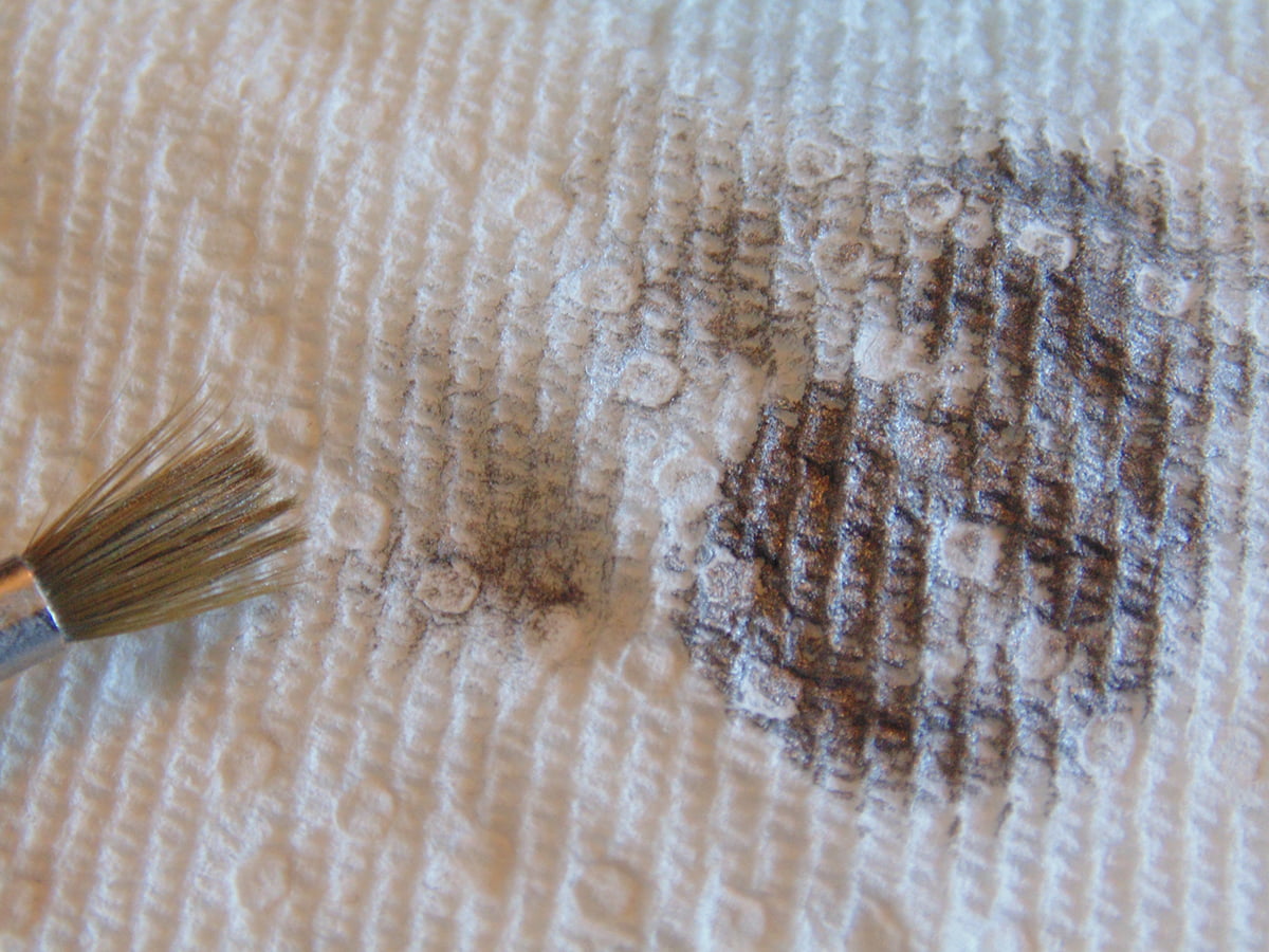 Brush Tip With Silver Paint And Brush Tip With Excess Paint On Paper Towel