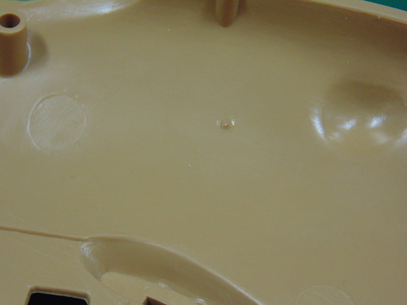 Pin Hole on the inside of the Sand-Colored Plastic Part
