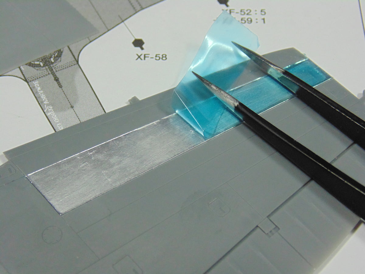 Transparent Blue Film with Tweezers and Metal Wing Part