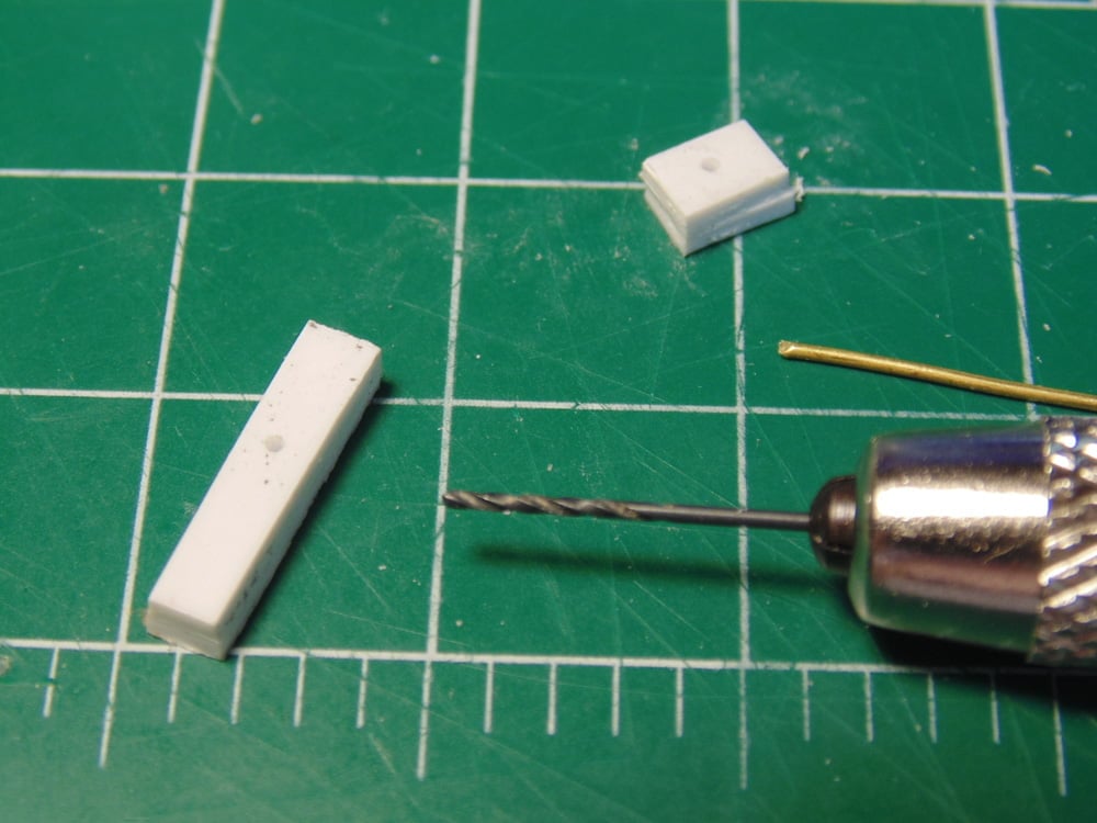 Two White Parts with Drill and Brass Pin