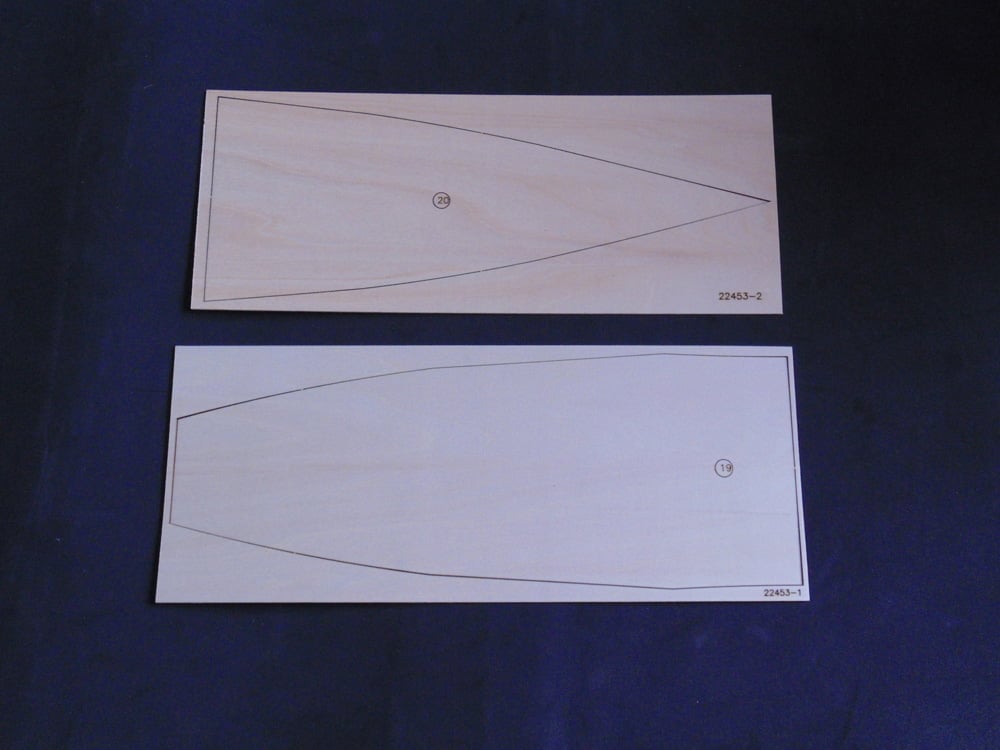 Two Sheets of Plywood on Black Backdrop