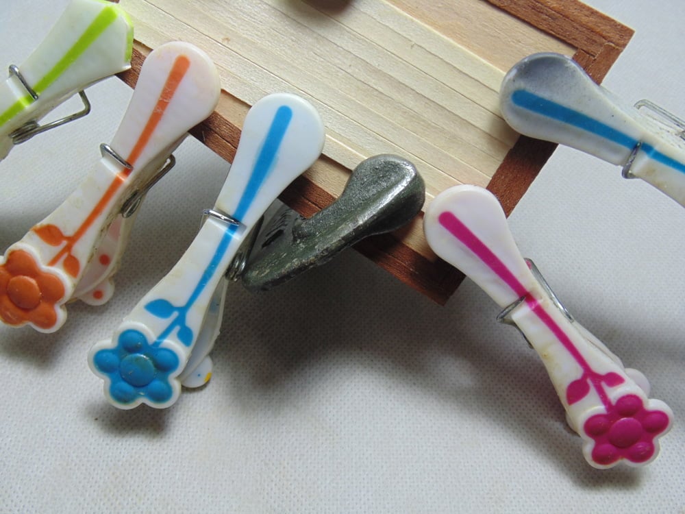 Plastic and a Metal Clamp on Planks