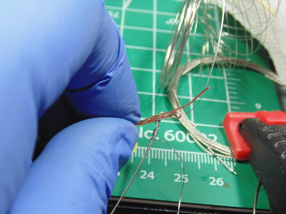 Gloves and Clamp Holding the Two Types of Wire