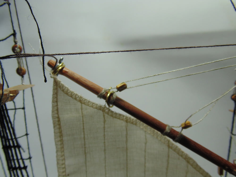 Tri-sail jib with metal loops pulling sail threads