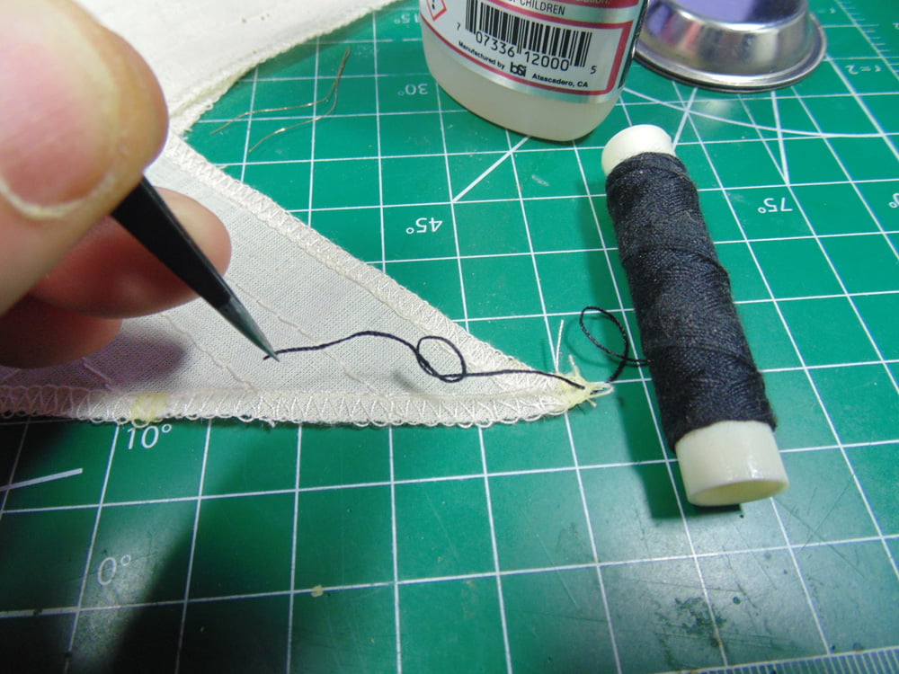 Black string roll with knot on sail