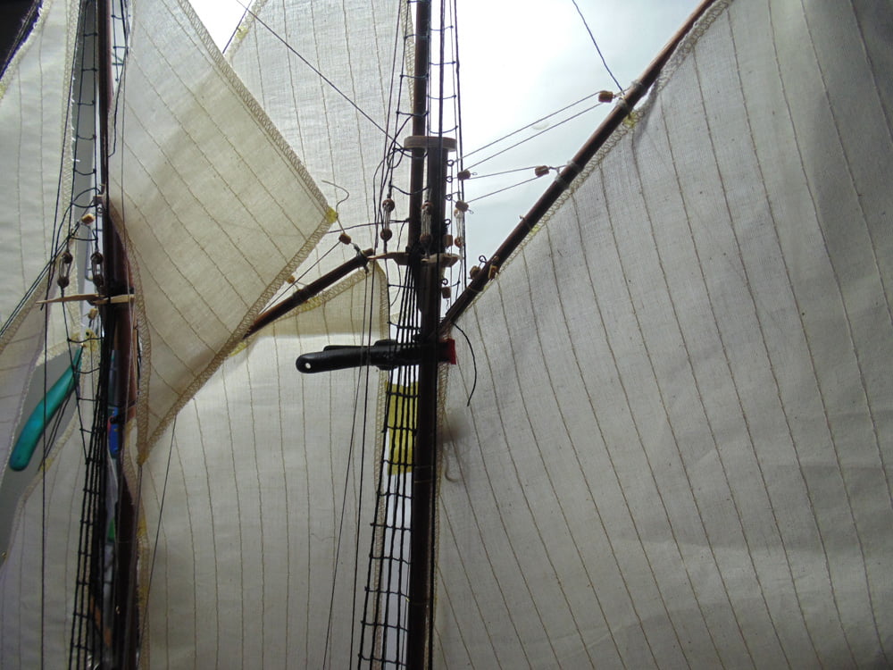 Clamp at the base of the upper boom on the sail