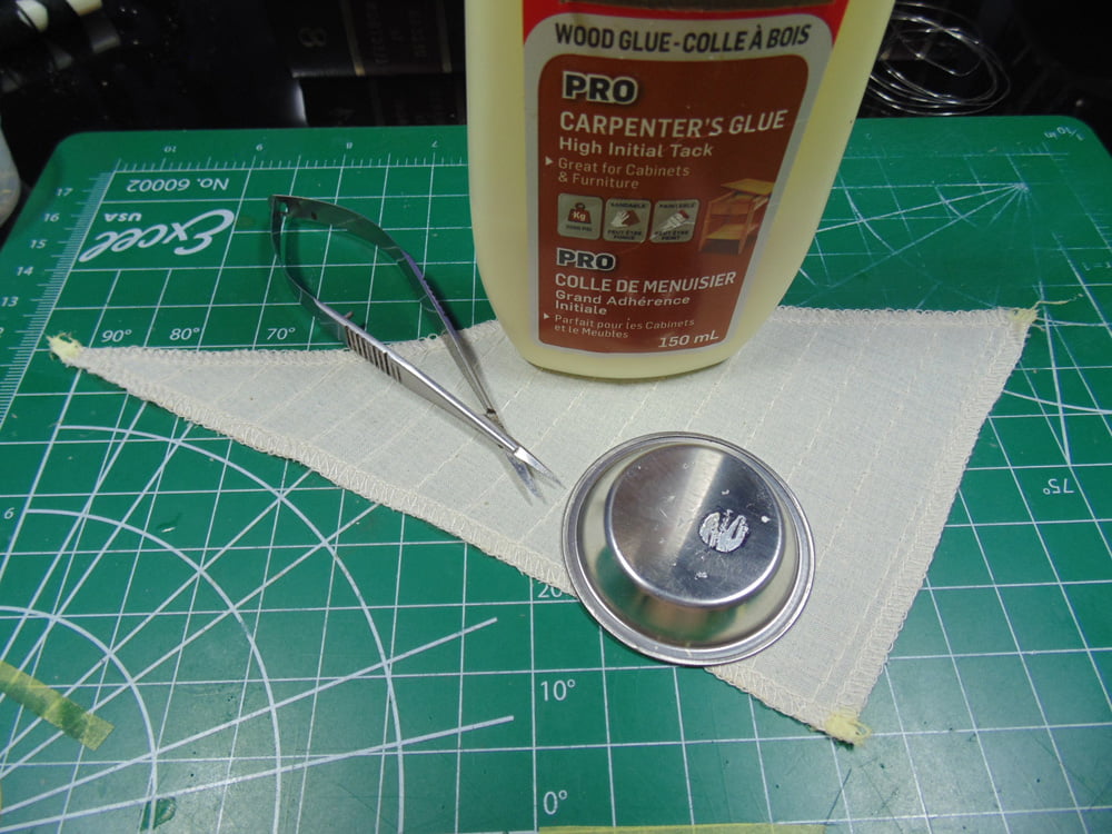 Glue tin cup and mini scissors on sail