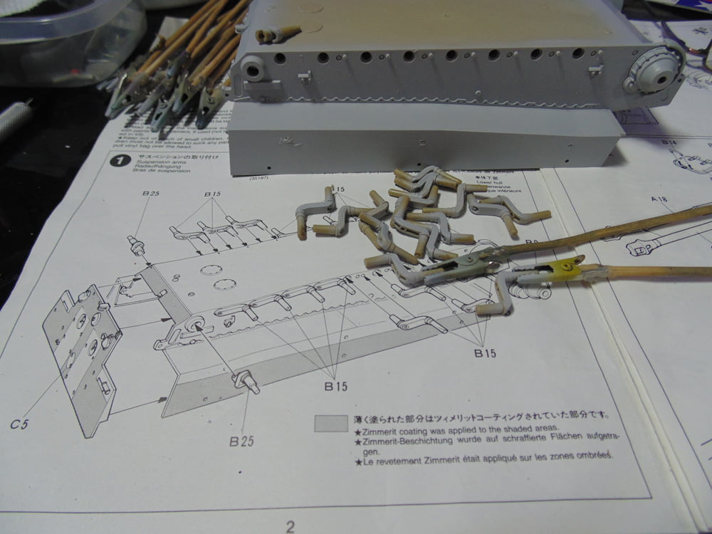 Suspension parts in front of the primed lower hull