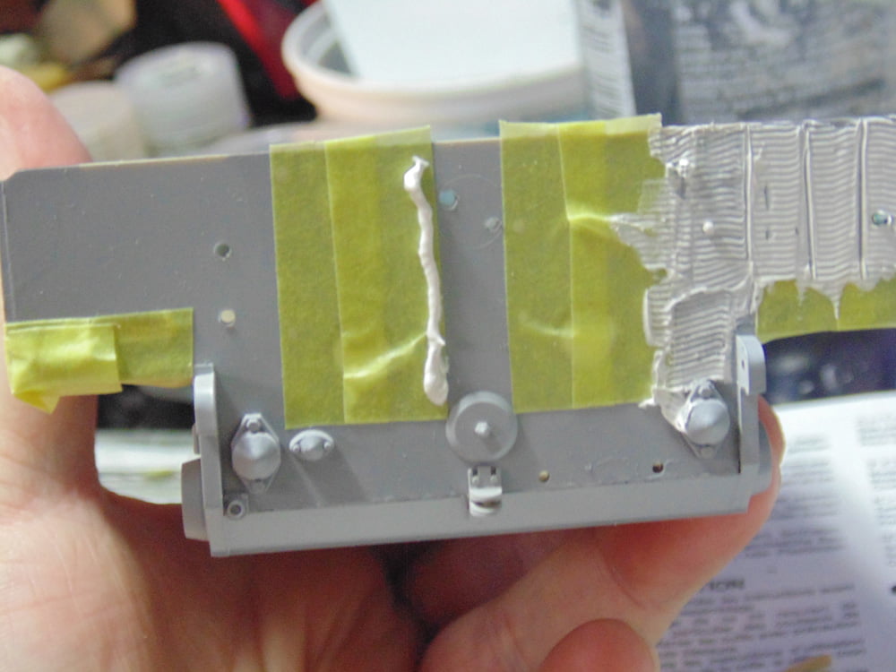 Completed right side rear with vertical bead of putty on tape
