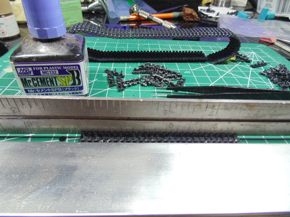 Metal holding down track parts