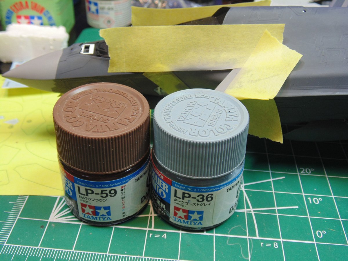 Two jars of paint in front of the model