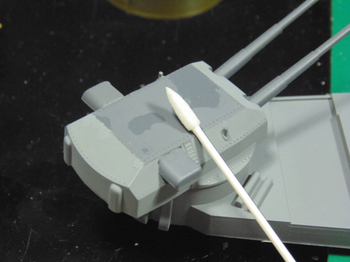 Pointed cotton swab over main turret