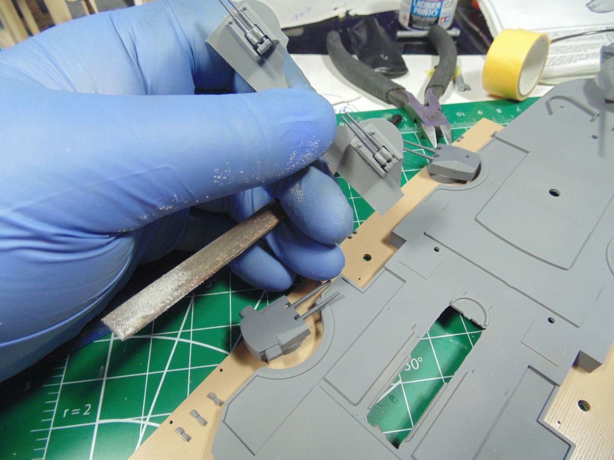 Blue glove holding AA parts