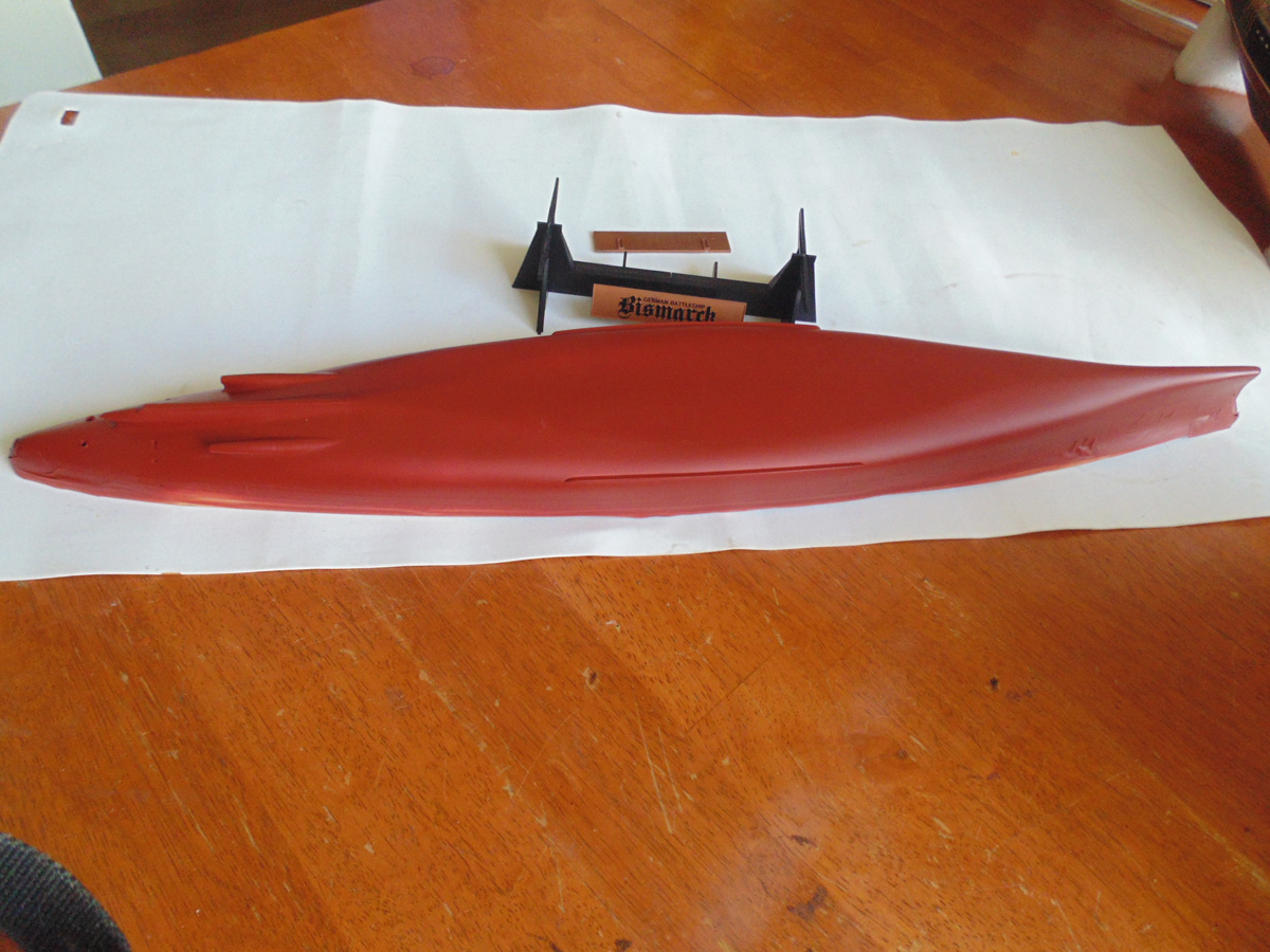 The hull sprayed in dull red with the stand above
